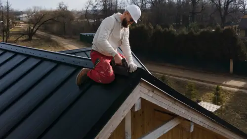 Roofer installing a new metal roof on a home.