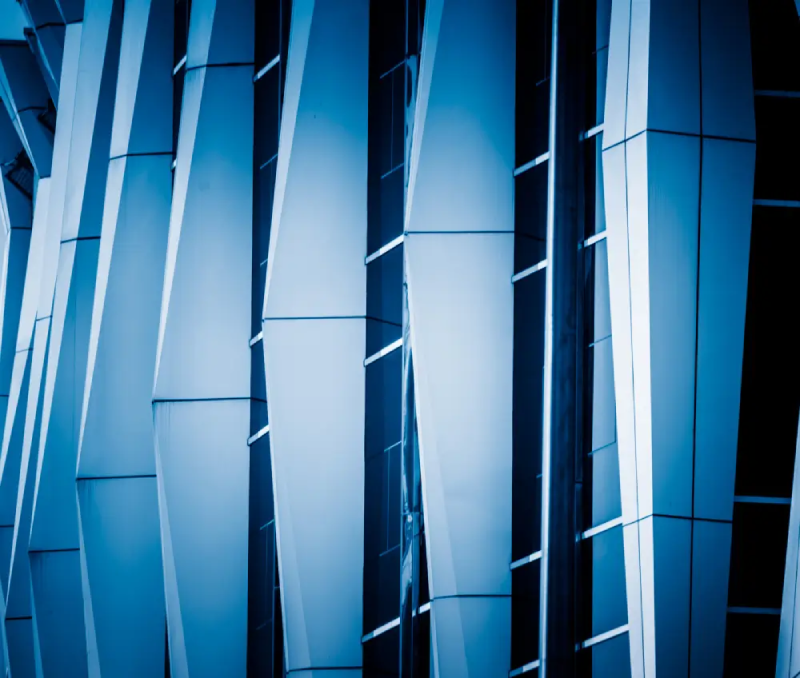 Modern blue building facade with geometric panels.
