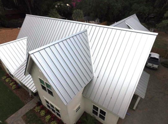 Modern home with a new metal roof, showcasing durable and stylish roofing.